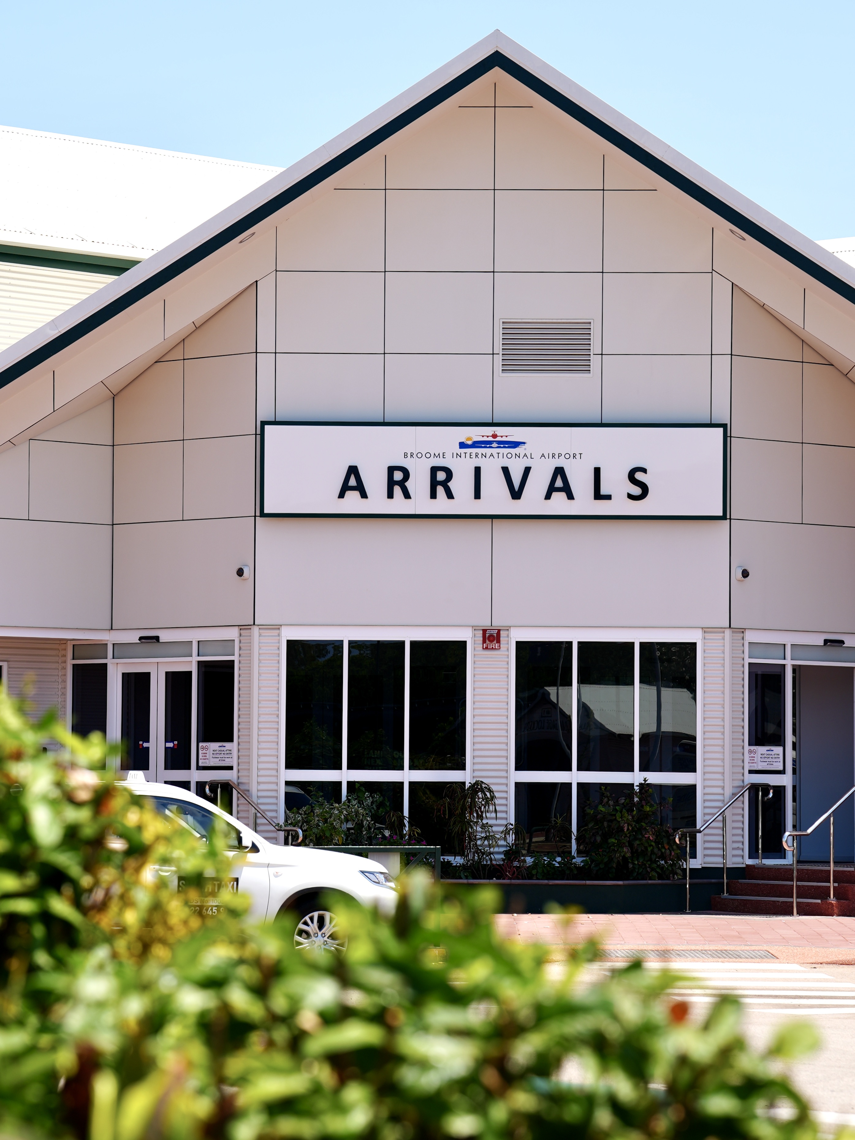 Broome International Airport Arrivals entrance with a taxi out front